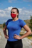 woman with protective mask  relaxing after running photo
