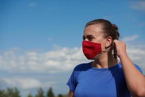 woman with protective mask  relaxing after running photo