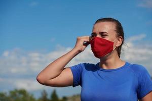 woman with protective mask  relaxing after running photo