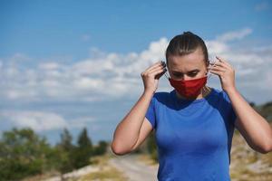 woman with protective mask  relaxing after running photo