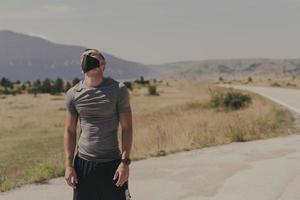 Young man and woman in protective masks running and doing exercises outdoors in the morning. Sport, Active life Jogging during quarantine. Covid-19 new normal. High quality photo. Selective focus. photo