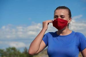 woman with protective mask  relaxing after running photo