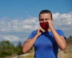 woman with protective mask  relaxing after running photo