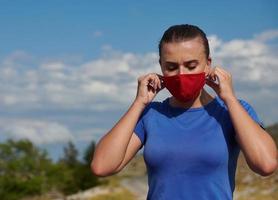 woman with protective mask  relaxing after running photo