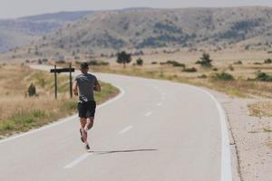 Young man and woman in protective masks running and doing exercises outdoors in the morning. Sport, Active life Jogging during quarantine. Covid-19 new normal. High quality photo. Selective focus. photo