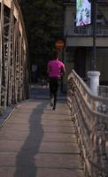 african american woman running across the bridge photo