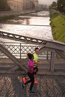 young multiethnic couple jogging in the city photo