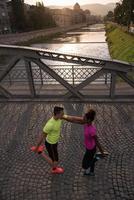 jogging couple warming up and stretching in the city photo