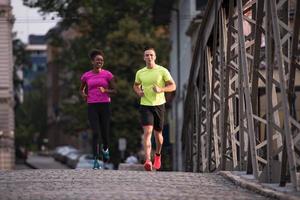 multiethnic couple jogging in the city photo