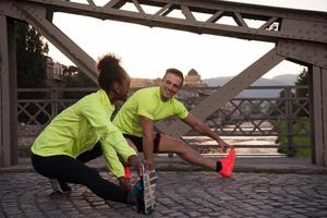 jogging couple warming up and stretching in the city photo