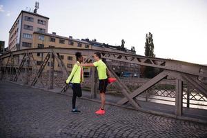 jogging couple warming up and stretching in the city photo