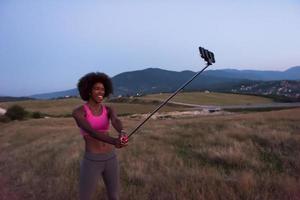 black woman photographing herself in nature photo