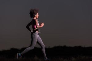 Young African american woman jogging in nature photo