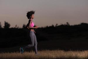 Young African american woman jogging in nature photo