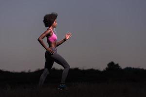 Young African american woman jogging in nature photo