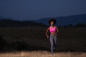 Young African american woman jogging in nature photo