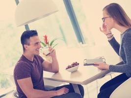 couple enjoying morning coffee and strawberries photo