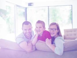 family with little boy enjoys in the modern living room photo