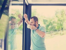 young man drinking morning coffee by the window photo