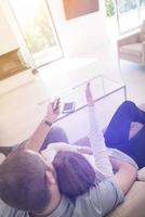 romantic couple on the sofa watching television photo