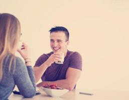 couple enjoying morning coffee and strawberries photo