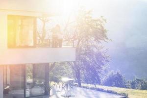 couple enjoying morning coffee on balcony photo