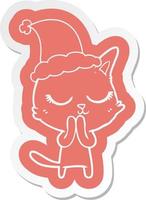 calm cartoon  sticker of a cat wearing santa hat vector