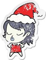 cute distressed sticker cartoon of a vampire girl wearing santa hat vector