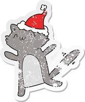 distressed sticker cartoon of a dancing cat wearing santa hat vector
