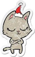 calm distressed sticker cartoon of a cat wearing santa hat vector