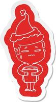 cartoon  sticker of a anxious boy carrying book wearing santa hat vector