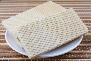 Two crisp waffles on a white plate. photo