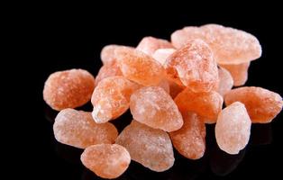 Pink Himalayan salt on a black background. photo