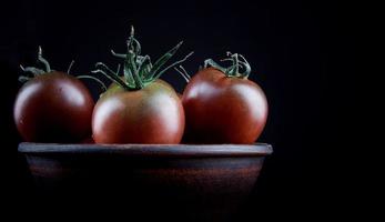 Three ripe tomatoes in earthenware. Cumato tomatoes. photo