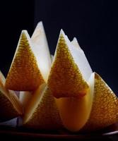 Shining slices of ripe melon on the light. photo