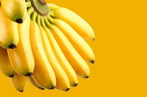 Bunch of bananas on a yellow background. Delicious ripe bananas. photo