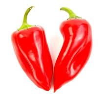 Two red ripe peppers are isolated on a white background. photo