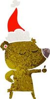 happy retro cartoon of a bear giving thumbs up wearing santa hat vector