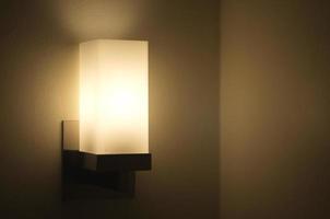 Sleeping head lamp. Lamp shines with light on the wall. Warm lighting. photo