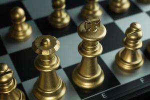 gold and silver chess on board close up image abstract Background. photo