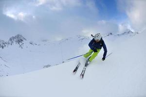 skiing on fresh snow at winter season at beautiful sunny day photo