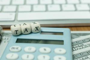 Tax wooden cubic on work table for business content. photo