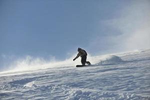 freestyle snowboarder jump and ride photo