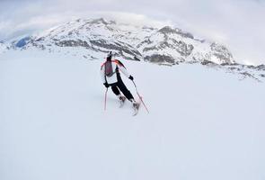 skiing on fresh snow at winter season at beautiful sunny day photo