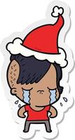 sticker cartoon of a crying girl wearing santa hat vector