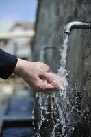 fresh mountain water falling on hands photo