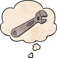 cartoon spanner and thought bubble in grunge texture pattern style vector