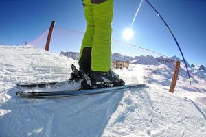 skiing on fresh snow at winter season at beautiful sunny day photo