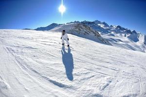 skiing on fresh snow at winter season at beautiful sunny day photo