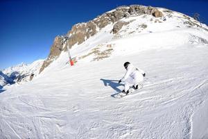 skiing on fresh snow at winter season at beautiful sunny day photo